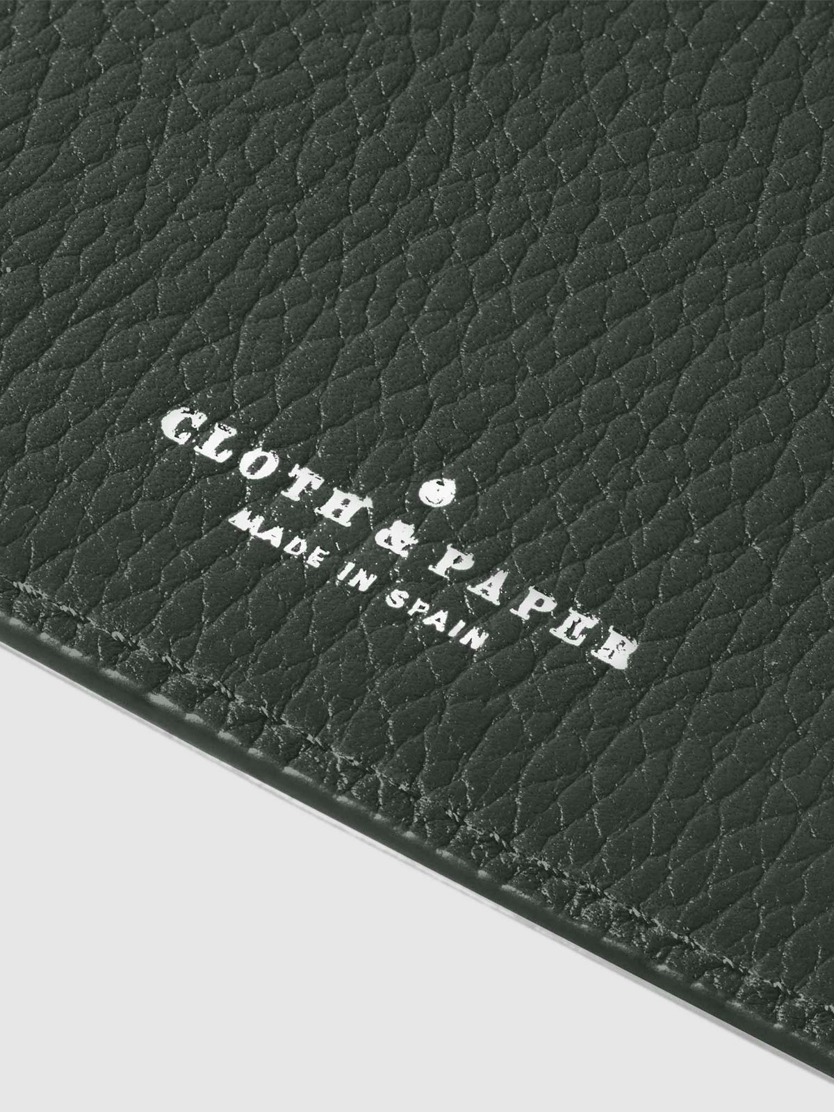 Closeup of silver stamping on leather folio.