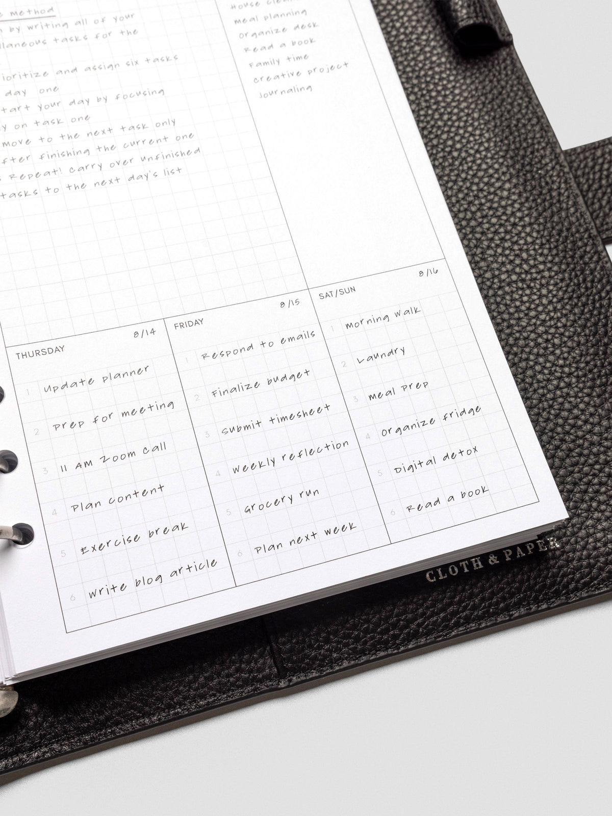 Close-up of a fully used Ivy Lee Priority Planner Insert page, showing handwritten tasks and notes across the entire weekly layout in a planner binder.