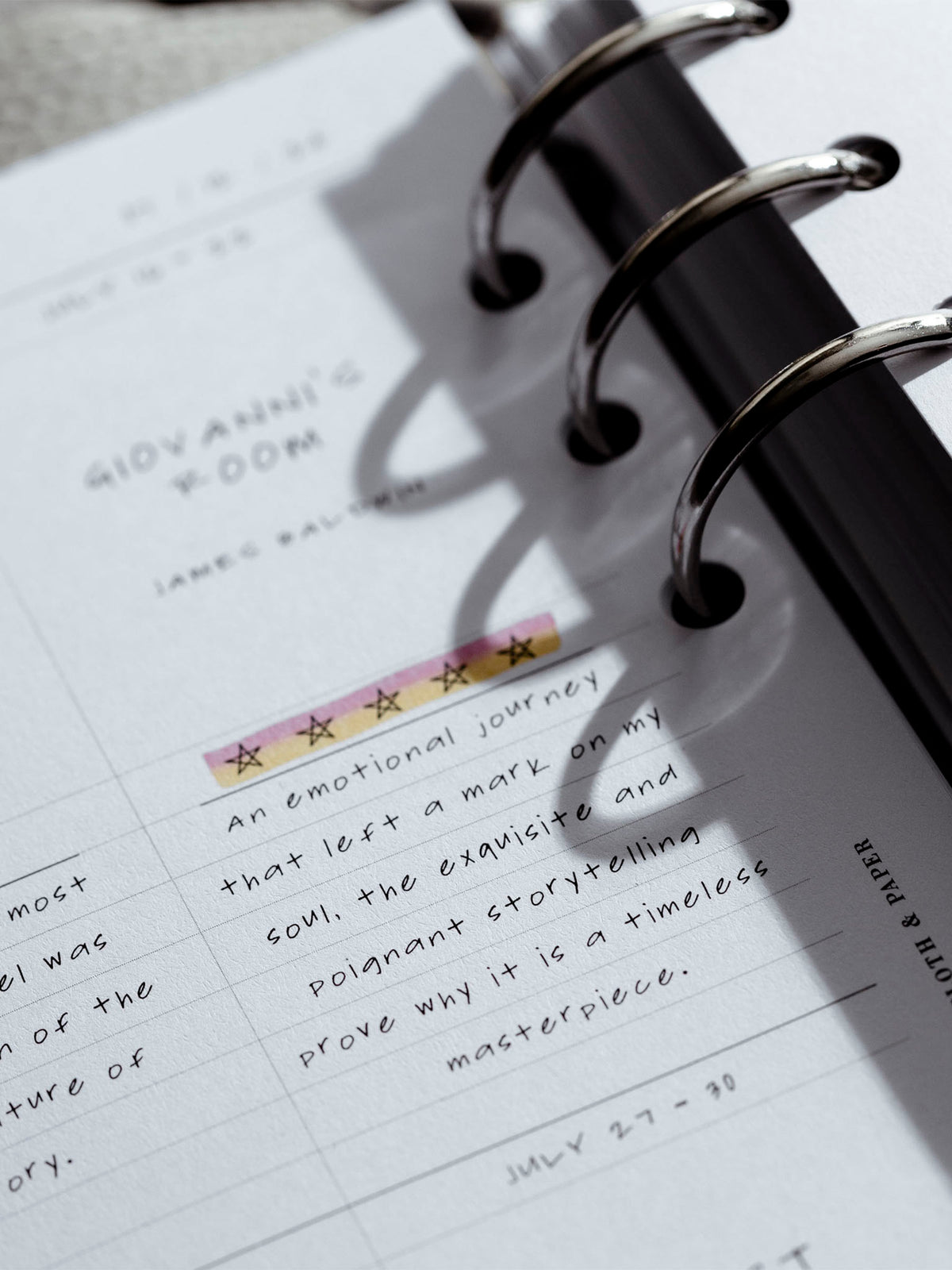 Insert in use inside of a ringed leather agenda. A book review is filled out in one of the spaces and rated 5 out of 5 stars.