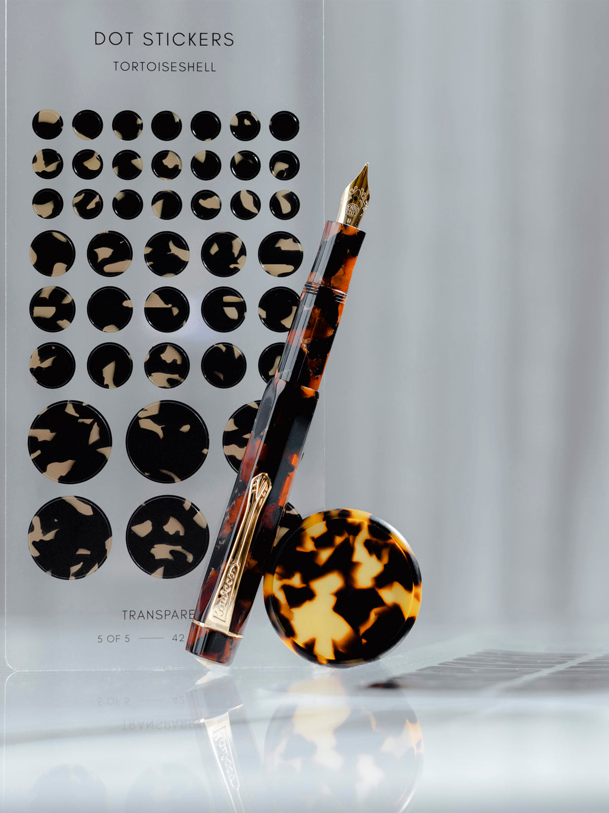 Hickory Brown pen shown alongside Tortoiseshell Dot Stickers and Tortoiseshell Planner Discs.