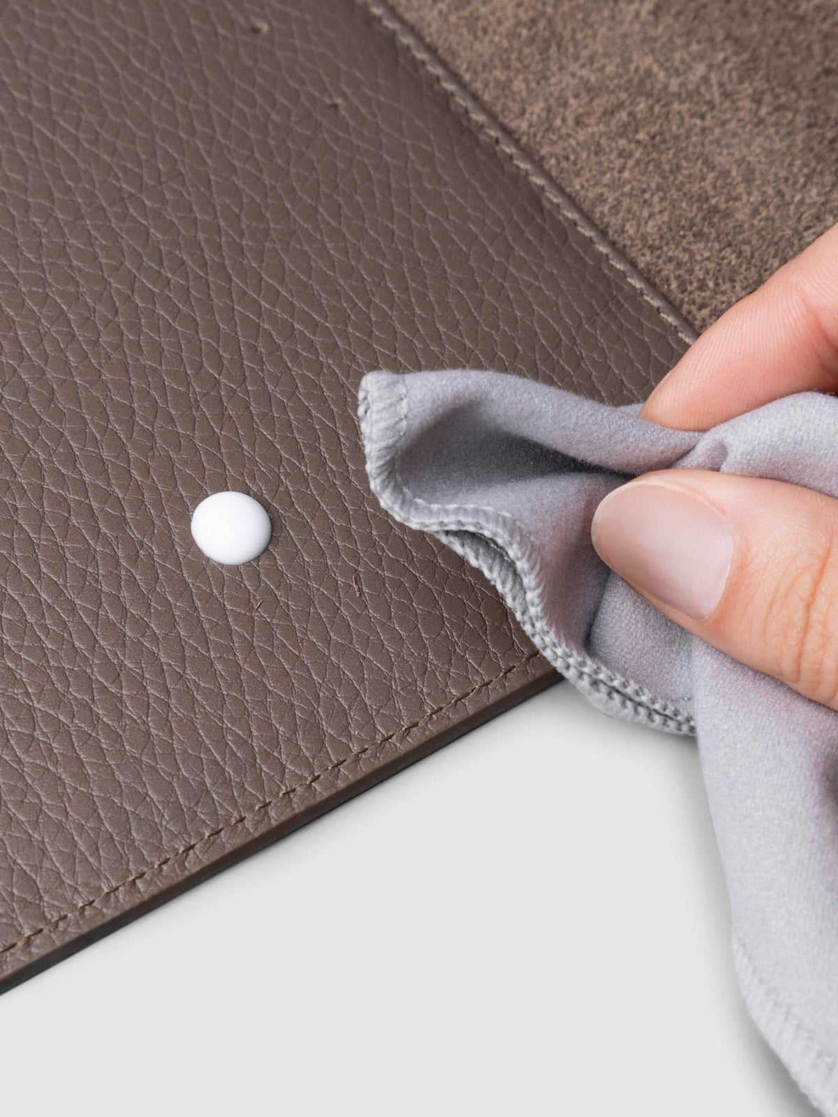 Conditioner in use inside a brown leather agenda.