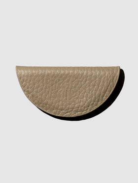 Brown leather bookmark on a neutral background.