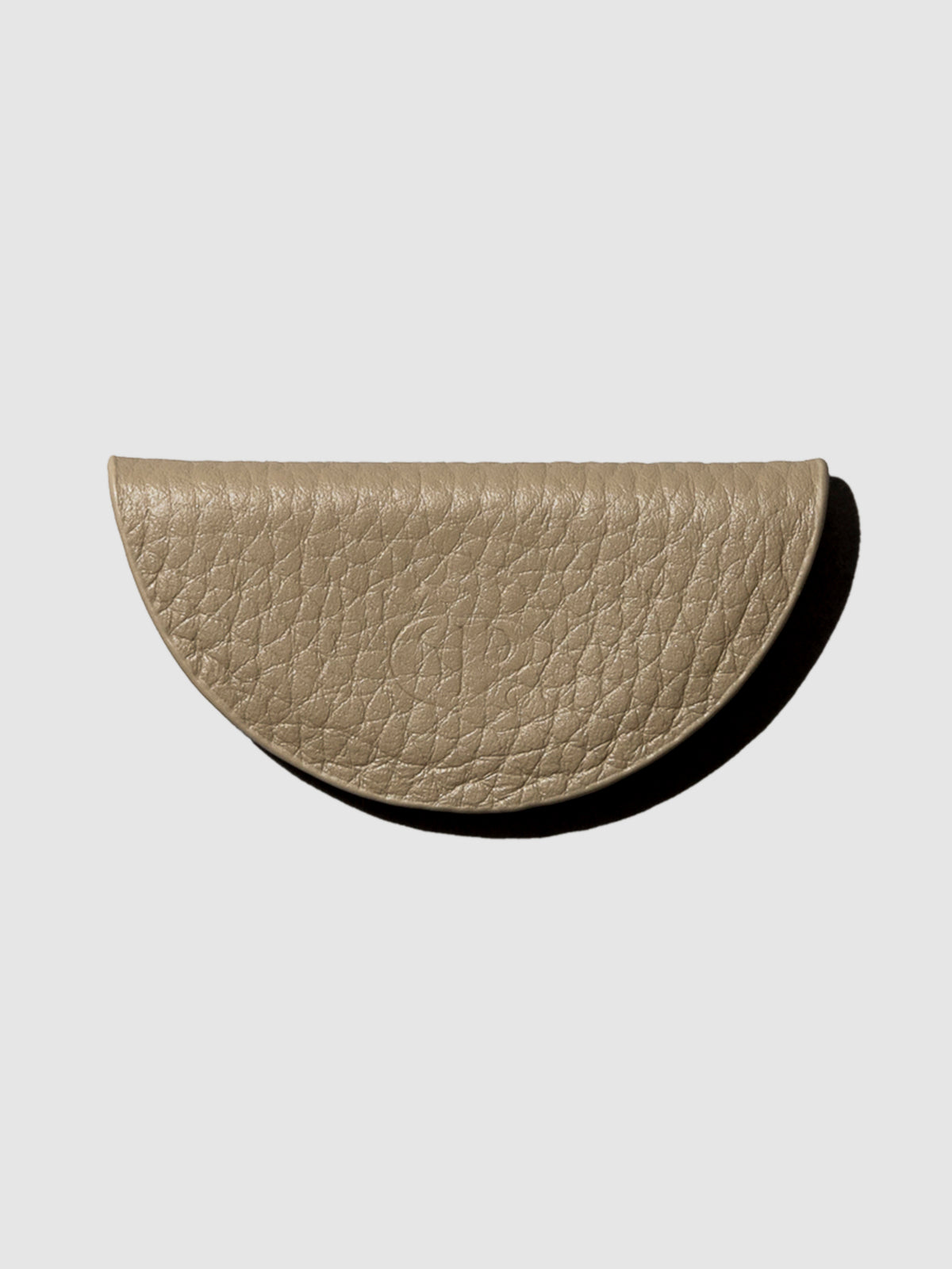 Brown leather bookmark on a neutral background.