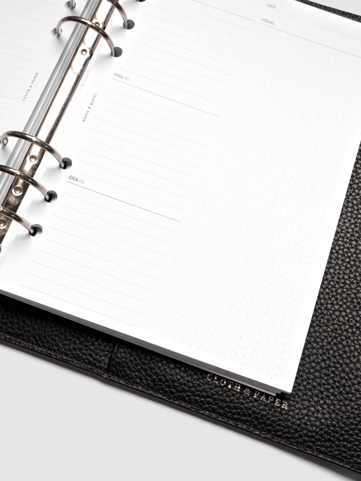 Close up of Mental Download inserts inside discbound planner and leather cover.