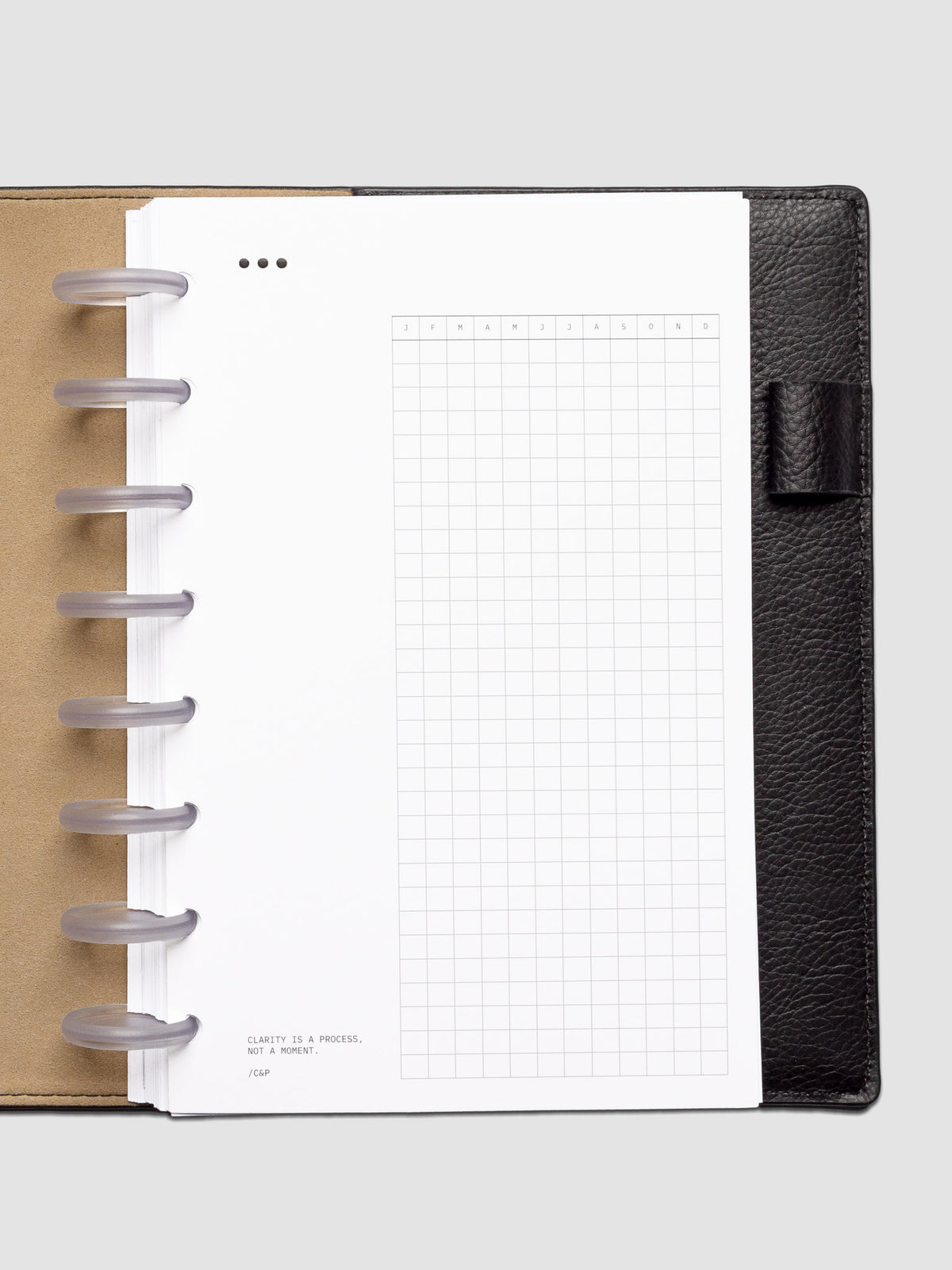 Mindful Moments Planner Dashboard in Half Letter size shown discbound in a leather folio.