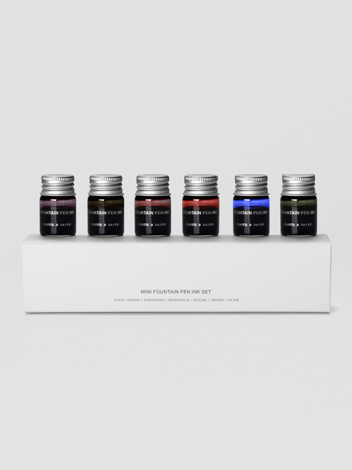 Set of six miniature bottles of fountain pen ink in six unique colors shown in packaging.