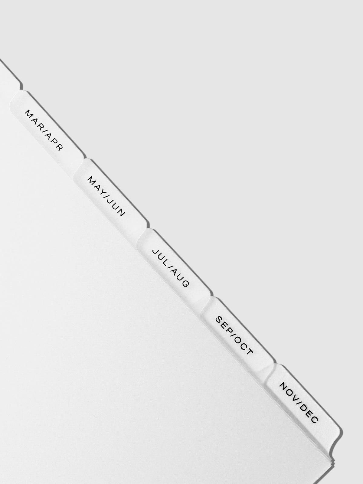 Closeup of black foil tabs displayed on a neutral background.