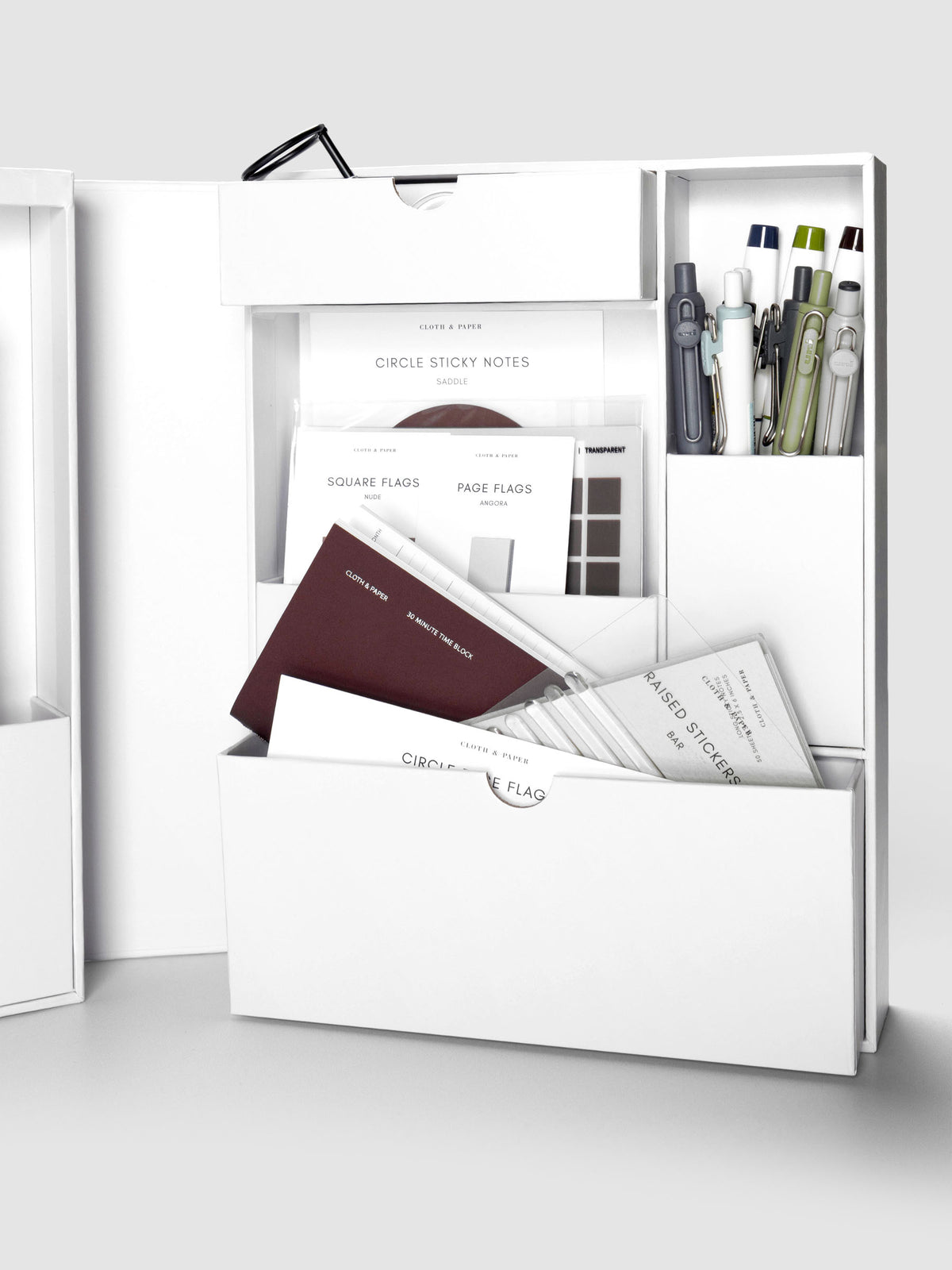Storage Book 4.0 archiving box open displaying the right hand side with pens, page flags, sticky notes, travel notebooks, and other accessories in various compartments.