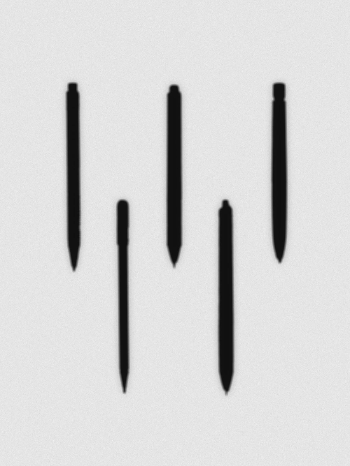 Five silhouettes of pens or pencils against a grey background.