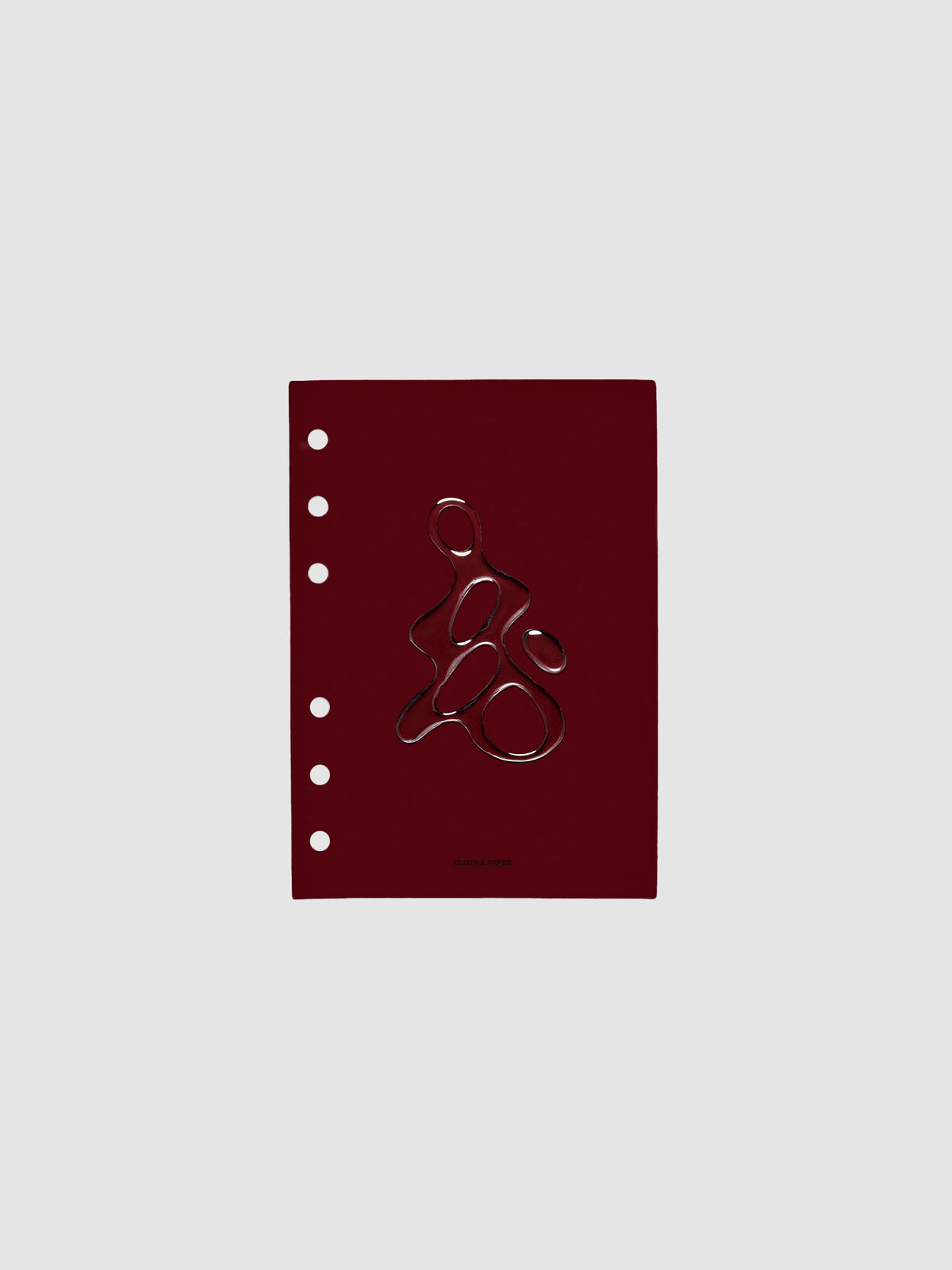Dark red, semi-transparent, and glossy plastic planner dashboard with organic raised shape design in size A6 on a neutral background.
