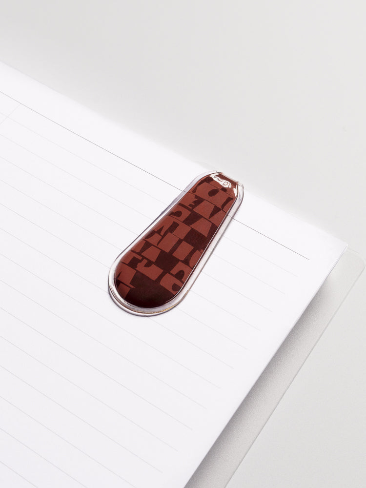 Bordeaux (red) Magnetic Bookmark attached to the inside of a planner.