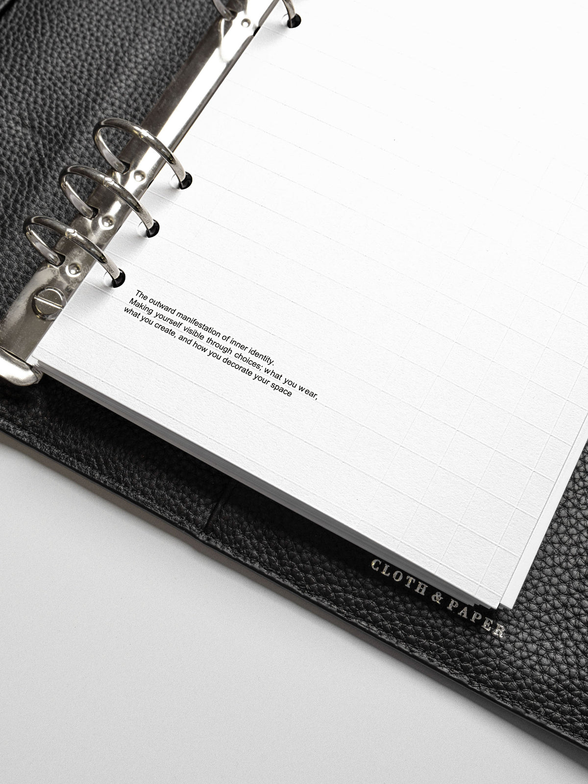 Detailed view of the lower corner of the A5 Tile Planner Dashboard showing a quote about inner identity printed on the page.