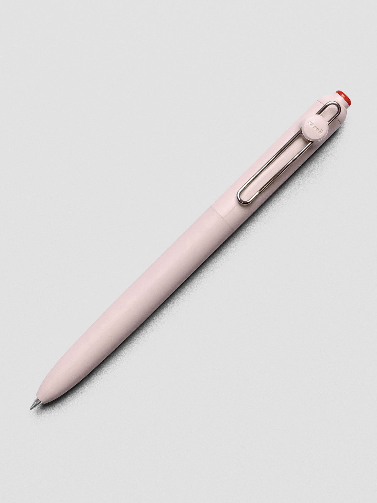 Pink/red pen shown at an angle with a silver clip.