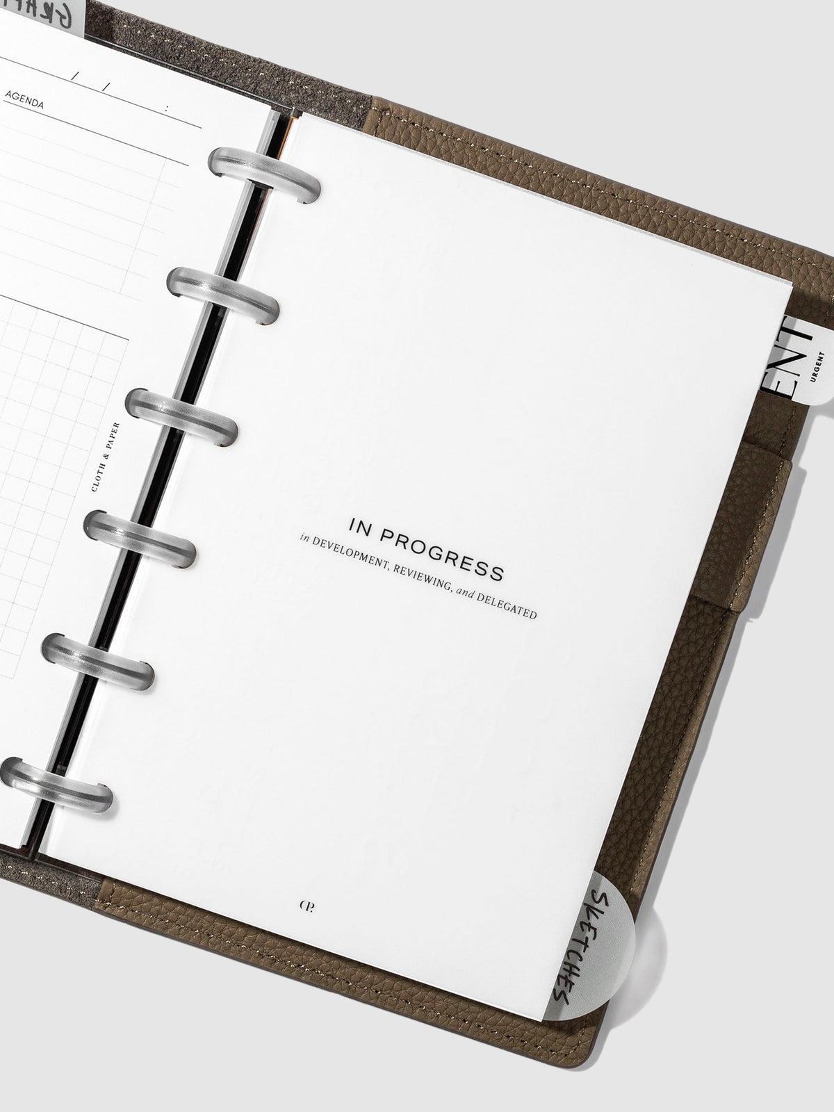 "In Progress" dashboard in use inside a leather planner cover.