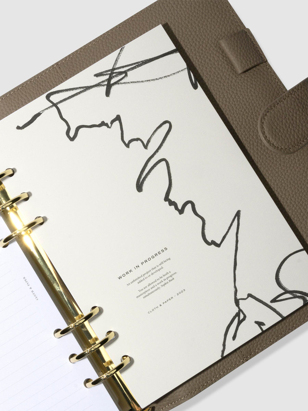 A5 planner with gold rings in a brown leather agenda featuring the work in progress planner dashboard.