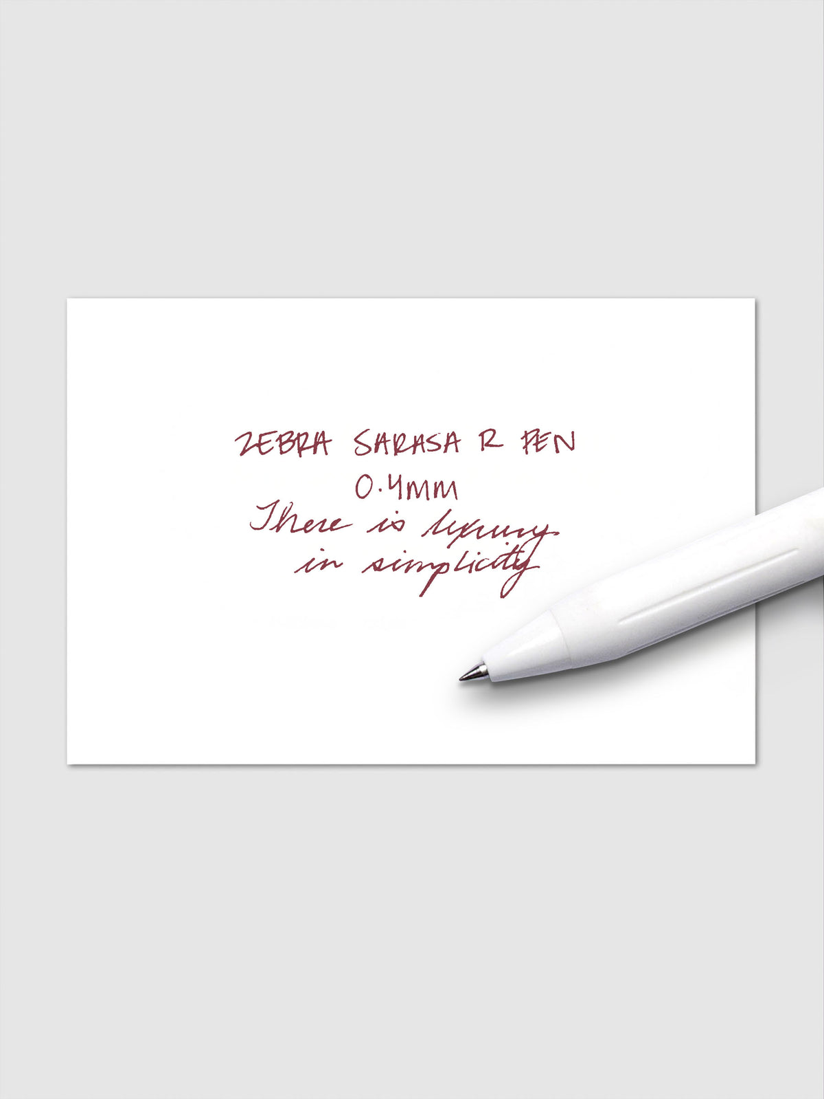 Writing sample using Zebra Sarasa R 0.4mm pen in red-black ink on white paper.