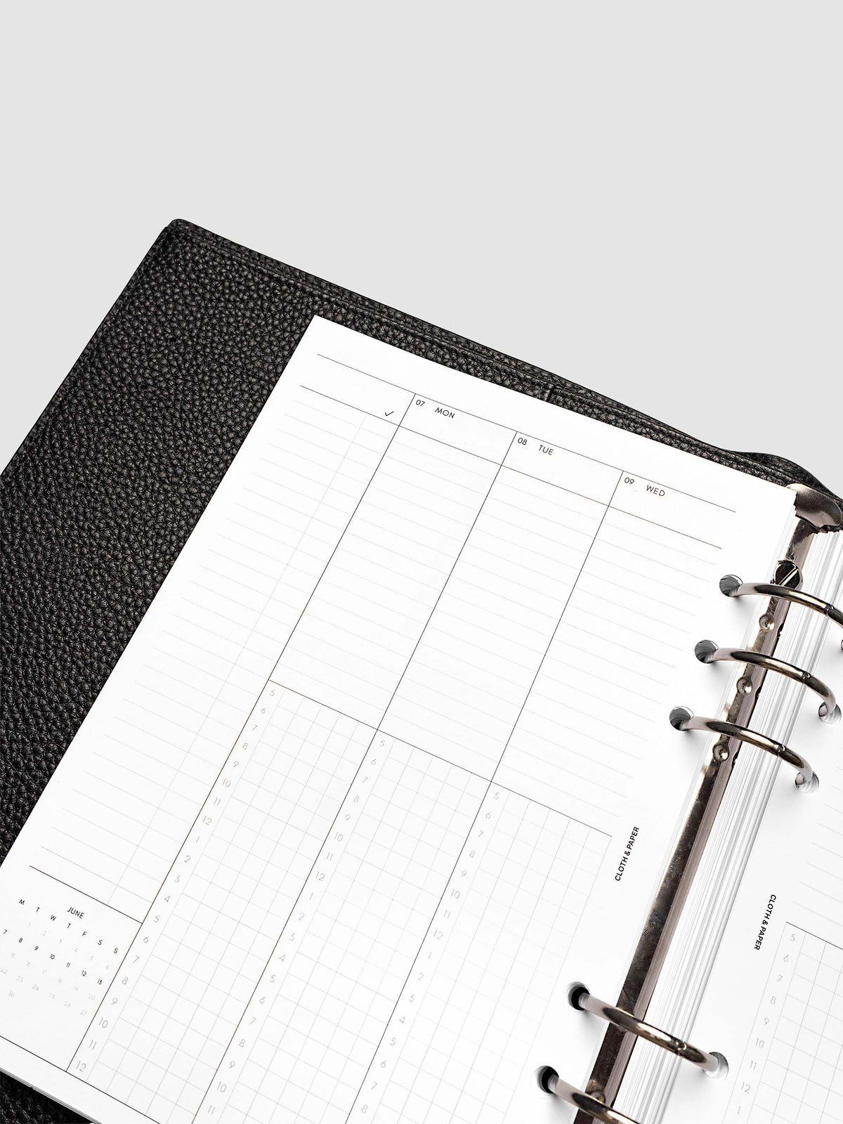 Punch left page detail showing task column, mini monthly calendar, and lined section in a planner
